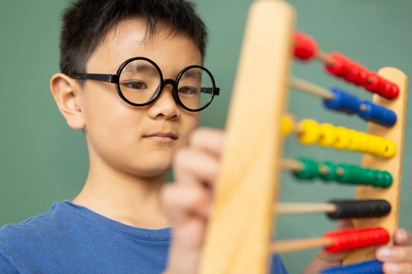 boy-learning-math-with-abacus-in-a-classroom-at-DE9N3LX-min.jpg